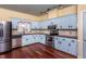 Spacious kitchen featuring blue cabinets and updated stainless steel appliances at 748 Weathergreen Dr, Raleigh, NC 27615