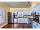 Stylish kitchen with light blue cabinets and stainless steel appliances at 748 Weathergreen Dr, Raleigh, NC 27615