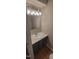 Cozy bathroom with a marble countertop sink and bright vanity lighting at 806 Kendall Dr, Durham, NC 27703