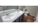 Bright bathroom features double sinks with modern fixtures and wood-look flooring at 806 Kendall Dr, Durham, NC 27703