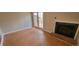 Living area features hardwood floors, a fireplace, and access to the backyard deck at 806 Kendall Dr, Durham, NC 27703