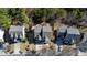 Aerial view of three houses with well-maintained lawns, driveways, and mature trees in a suburban neighborhood at 857 Stroud Cir, Wake Forest, NC 27587