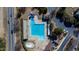 Aerial view of a community pool with lap lanes, a slide, a kiddie pool, parking, and surrounding greenery at 857 Stroud Cir, Wake Forest, NC 27587