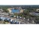 Aerial view featuring a lake, golf course, swimming pool, and houses nestled among the trees in a neighborhood at 857 Stroud Cir, Wake Forest, NC 27587