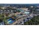 Aerial view showcasing a community pool and a scenic lake with green surroundings in a residential neighborhood at 857 Stroud Cir, Wake Forest, NC 27587
