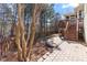 Landscaped backyard with stone patio and stairs leading to the deck at 857 Stroud Cir, Wake Forest, NC 27587