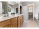 This well-lit bathroom has double sinks with a full vanity and an entry to the bathtub at 857 Stroud Cir, Wake Forest, NC 27587