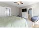 This neutral-colored bedroom has carpeted floors, with a bathroom and closet accessible from the space at 857 Stroud Cir, Wake Forest, NC 27587