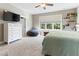 Bedroom with large window, wall-mounted tv, and lots of natural light at 857 Stroud Cir, Wake Forest, NC 27587