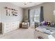 A well-lit room features a bed and armchair, with a dresser providing ample storage at 857 Stroud Cir, Wake Forest, NC 27587