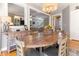 Charming dining area open to the living space with hardwood floors and warm lighting at 857 Stroud Cir, Wake Forest, NC 27587