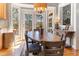 Cozy dining area with deck access featuring hardwood floors and lovely lighting fixture at 857 Stroud Cir, Wake Forest, NC 27587