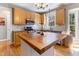 Bright kitchen with light wood cabinets, butcher block island, and stainless steel appliances at 857 Stroud Cir, Wake Forest, NC 27587