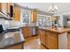 Bright kitchen with stainless appliances, light wood cabinets, and island adjacent to dining area at 857 Stroud Cir, Wake Forest, NC 27587