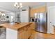 Bright kitchen with stainless steel appliances, wooden island, and open layout at 857 Stroud Cir, Wake Forest, NC 27587