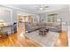 Spacious living room with hardwood floors, large sectional, and view into the kitchen at 857 Stroud Cir, Wake Forest, NC 27587