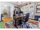 Bright office features large window with shutters, hardwood floors, and stylish rug at 857 Stroud Cir, Wake Forest, NC 27587