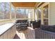 Cozy screened porch with wicker furniture and a relaxing hot tub at 857 Stroud Cir, Wake Forest, NC 27587