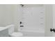 A well-lit bathroom features a tub and shower combination with a matte black shower head at 915 E Holly St, Rocky Mount, NC 27801
