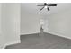 An empty bedroom features a modern ceiling fan, gray vinyl floors, and light-filled windows at 915 E Holly St, Rocky Mount, NC 27801