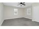 The bedroom features gray floors, a ceiling fan and two windows for natural light at 915 E Holly St, Rocky Mount, NC 27801