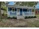 Charming blue house with a covered front porch, white railings, and landscaped front yard at 915 E Holly St, Rocky Mount, NC 27801
