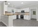 Modern kitchen with white cabinetry, stainless steel appliances, wood countertops, and mosaic backsplash at 915 E Holly St, Rocky Mount, NC 27801