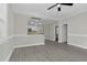 Open concept view of the bright living room featuring gray floors, white walls, and an open kitchen at 915 E Holly St, Rocky Mount, NC 27801