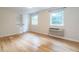 Bright bedroom with hardwood floors and natural light streaming through two windows at 979 St Marys St # G6, Raleigh, NC 27605