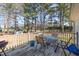 A cozy back deck with an outdoor dining set overlooks a spacious yard with mature trees at 1001 Strobus Ct, Wendell, NC 27591