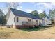 A well-maintained backyard features a deck and a classic white home with a dark roof at 1001 Strobus Ct, Wendell, NC 27591