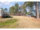 Expansive backyard showing outdoor shed, mature trees, and ample green space for various activities at 1001 Strobus Ct, Wendell, NC 27591