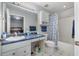 Bright bathroom with a blue countertop vanity, shower with blue patterned curtain, and tiled flooring at 1001 Strobus Ct, Wendell, NC 27591