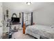 Serene bedroom featuring exercise equipment, a bed, and a TV, complemented by natural light from a corner window at 1001 Strobus Ct, Wendell, NC 27591