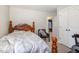 Bedroom featuring a bed with floral patterned bedding, chair, and view into the living room through an open door at 1001 Strobus Ct, Wendell, NC 27591
