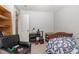 Comfortable bedroom with a single bed, study desk, and chair, illuminated by natural light from the doorway at 1001 Strobus Ct, Wendell, NC 27591