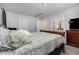 Well-lit bedroom featuring a plush bed with patterned linens and an adjacent door to the connected bathroom at 1001 Strobus Ct, Wendell, NC 27591