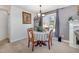 Cozy dining area with seating for four, a classic chandelier, and a large window for natural light at 1001 Strobus Ct, Wendell, NC 27591