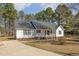 Beautiful home featuring a front porch and driveway, surrounded by mature trees and a well-maintained lawn at 1001 Strobus Ct, Wendell, NC 27591