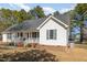 Charming home with a covered front porch, featuring brick accents and lush green lawn at 1001 Strobus Ct, Wendell, NC 27591