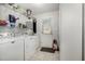 Functional laundry room with washer, dryer, shelving, and access to the backyard, offering convenience at 1001 Strobus Ct, Wendell, NC 27591