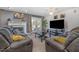 Inviting living room features a fireplace, comfortable seating, large TV, and access to an outdoor patio at 1001 Strobus Ct, Wendell, NC 27591
