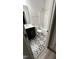 Bathroom with black and white patterned tile flooring, vanity, toilet, and shower with tub at 1013 Greatland Road, Durham, NC 27703