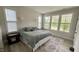 Well-lit bedroom with large windows offering verdant outdoor views at 1013 Greatland Road, Durham, NC 27703