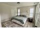 Bright bedroom featuring wood-look floors, a neutral color palette, and a plush rug at 1013 Greatland Road, Durham, NC 27703