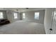 Spacious bonus room featuring neutral carpet, three windows, and neutral paint at 1013 Greatland Road, Durham, NC 27703