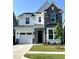 Beautiful two-story home with a stone facade and manicured lawn showcases classic design at 1013 Greatland Road, Durham, NC 27703