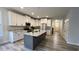 Spacious kitchen with an island featuring granite countertops and stylish white cabinetry at 1013 Greatland Road, Durham, NC 27703