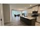 Open kitchen with a center island, granite countertops, stainless steel appliances, and white cabinets at 1013 Greatland Road, Durham, NC 27703