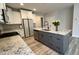 Modern kitchen island with a sink, gray cabinets, and granite countertops at 1013 Greatland Road, Durham, NC 27703